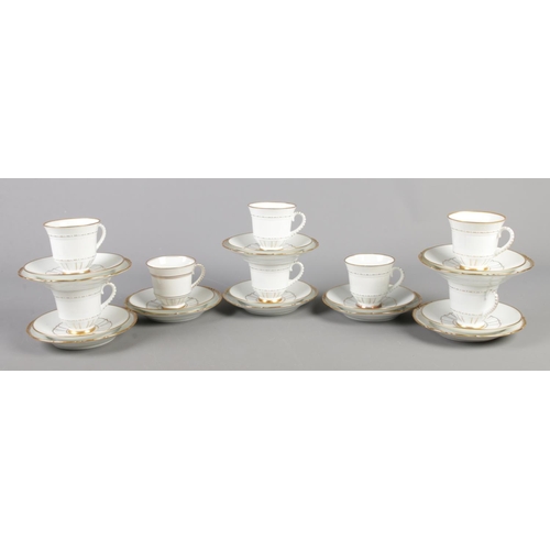 137 - A twenty-four piece Bing and Grondahl teacup, saucer and side plate set, in white with gilt decorati... 