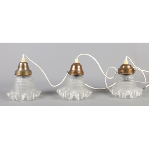 268 - Three vintage light fittings, with frilled glass shades.