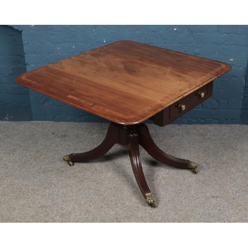 631 - A Regency mahogany Pembroke table with single drawer. Raised on reeded splayed legs with brass lion ... 