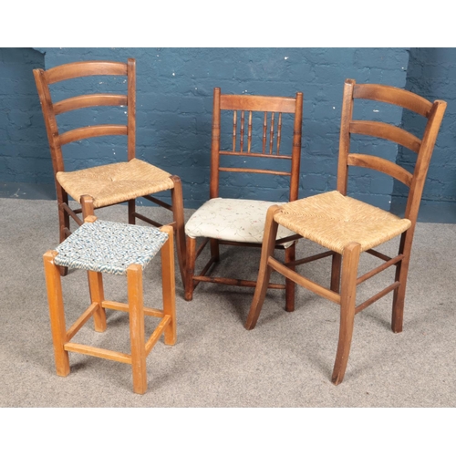 607 - A pair of rush seat ladder back chairs along with a small chair and stool.