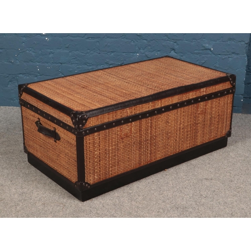 609 - A large wood and rattan trunk.