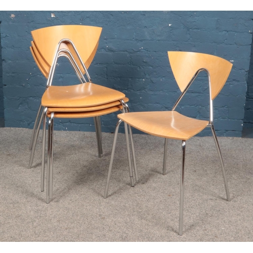 616 - A set of four stacking chairs with chrome supports.