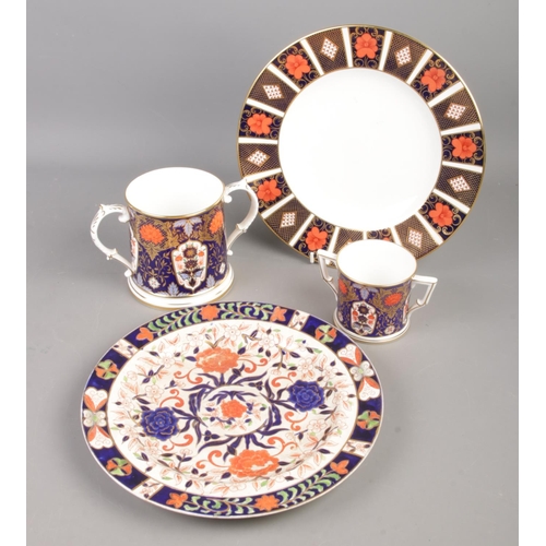 101 - Four pieces of Imari ceramics. To include Royal Crown Derby A1314 plate, two Derby Hamilton twin han... 