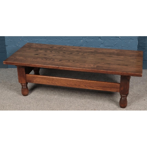 617 - An oak coffee table. (43cm x 135cm)