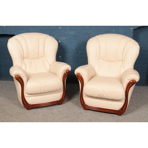 621 - A modern cream leather three piece suite, comprising of a three-seater sofa and two arm chairs. Widt... 