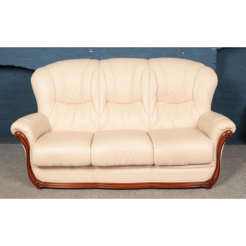 621 - A modern cream leather three piece suite, comprising of a three-seater sofa and two arm chairs. Widt... 