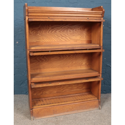 643 - A Globe Wernicke style oak three tier stacking bookcase with gallery top. (125cm x 87cm x 27cm)