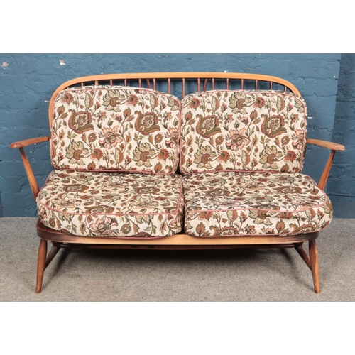 644 - An Ercol two seat sofa.