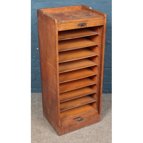 645 - An oak tambour front filing cabinet. (102cm x 43cm)
