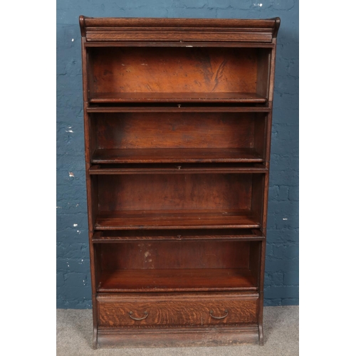 646 - A Globe Wernicke style oak four tier stacking bookcase with drawer base. (162xm x 87cm x 34cm)