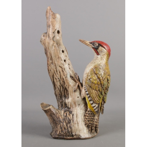 107 - A pottery Woodpecker sculpture. Signed and dated N Dalrymple 2002, H 37cm.