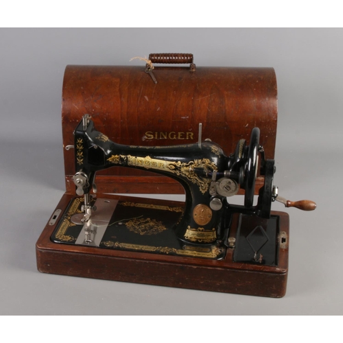 109 - A dome top cased singer sewing machine, numbered Y7033976.