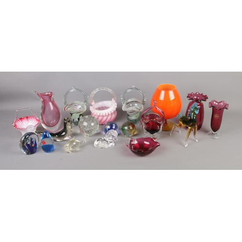 252 - A collection of art and cranberry glass to include animals, baskets, paperweights, etc.