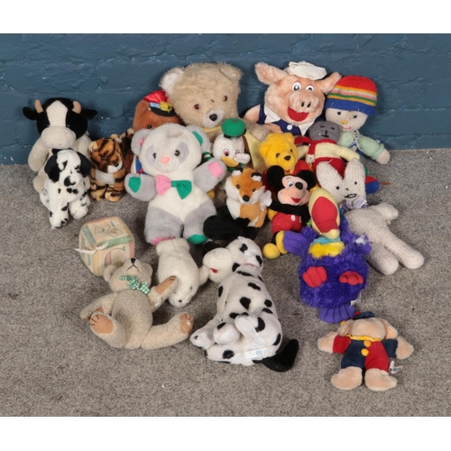 286 - A collection of soft toys to include Winnie the Pooh, Mickey Mouse, play blocks, etc.