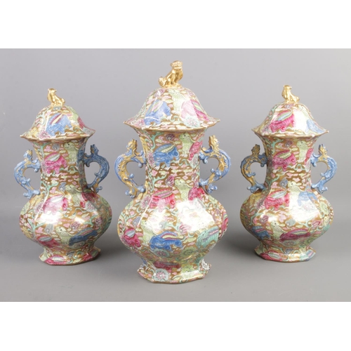 41 - A Chinese garniture set comprising of three lidded vases. Baring Jaiqing character marks. Tallest ex... 
