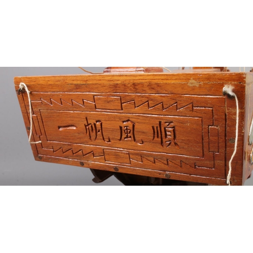 47 - A wooden model of a ship with oriental decoration. (60cm x 60cm)