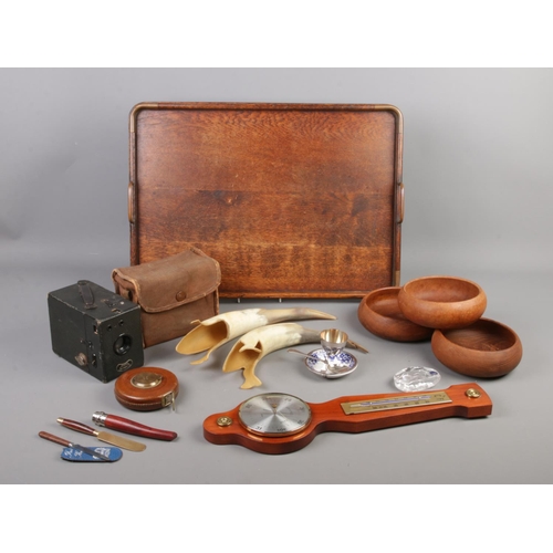 49 - A wooden tray of assorted collectables, to include tape measure, horns, box camera and treen bowls e... 