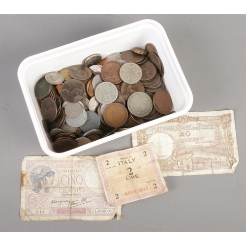 50 - A box of British and world coins and bank notes. Including George V florin and half crown, Victorian... 
