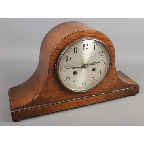 58 - An oak cased dome shaped mantel clock. Movement stamped Haller.