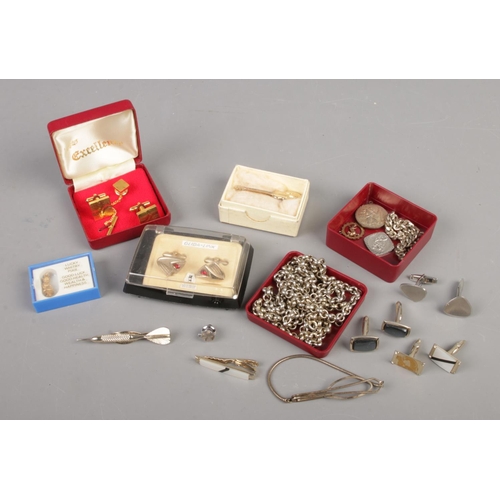 68 - A collection of gentleman's accessories. Includes tie slides, cufflinks, white metal chains, St Chri... 
