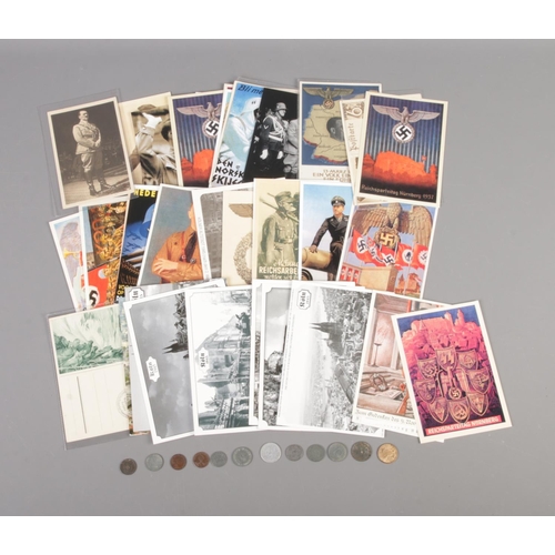 79 - A collection of replica Third Reich postcards along with small quantity of Third Reich WWII coins.