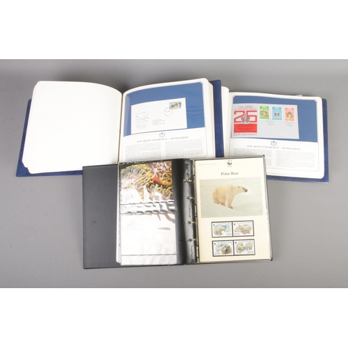82 - An album of WWF collectors stamps along with two albums of Queen Elizabeth II silver jubilee first d... 
