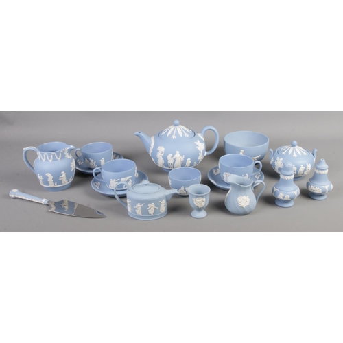 87 - A collection of Wedgwood tableware in sky blue jasperware. To include teapot, salt and pepper pots, ... 