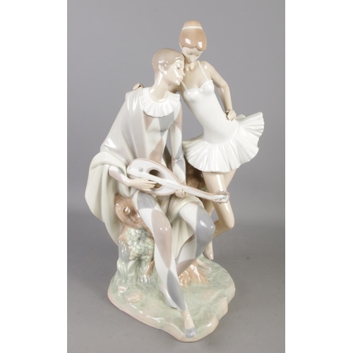 575 - A large Lladro figure group, Romance, modelled as a harlequin playing a mandolin and ballet dancer. ... 