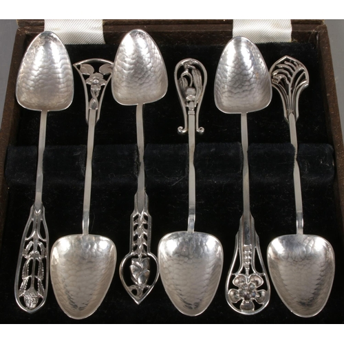 576 - A cased set of James Linton silver arts and crafts coffee spoons depicting various Australian flora.