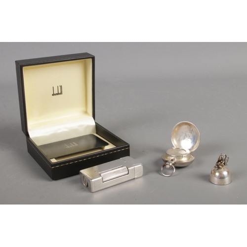 577 - A silver plated Dunhill lighter in box, together with a silver sovereign holder and tooth fairy toot... 