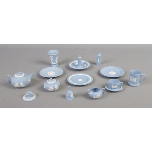 89 - A quantity of Wedgwood miniatures in sky blue jasperware. To include cup and saucer, candlestick, te... 