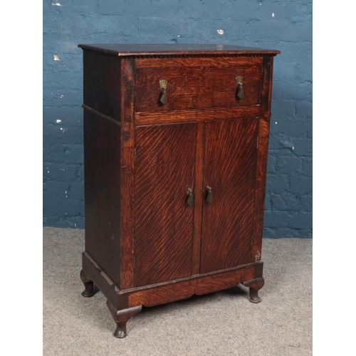 588 - An oak side cupboard with drawer.