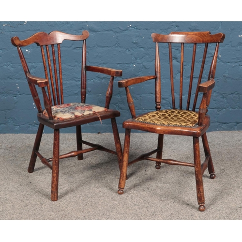 597 - Two child's armchairs, with upholstered seat pads and spindle backs.