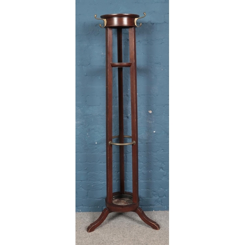 599 - A large mahogany cylindrical coat and stick stand, with drip tray. 173cm tall.