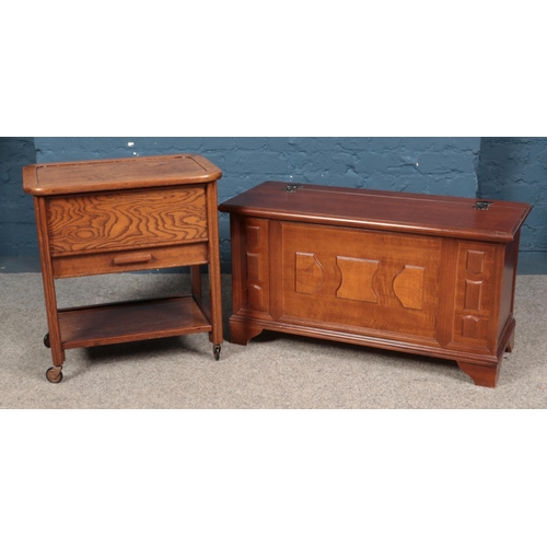 602 - A small yew wood blanket box, together with a vintage 'Arnold' sewing trolley.