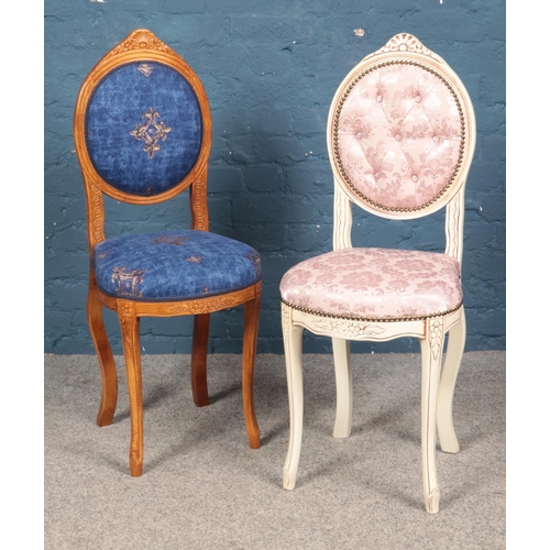 606 - Two modern carved hall chairs, of very similar design. Includes one painted example.