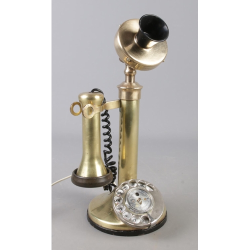 101 - A brass stick rotary dial telephone.