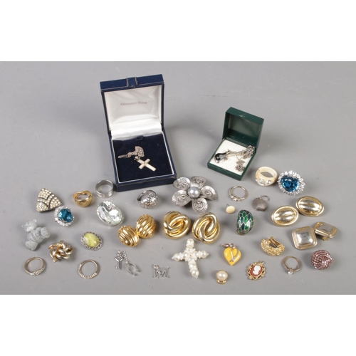 102 - A collection of jewellery. Includes two silver chains with pendants, clip on earrings, rings etc.