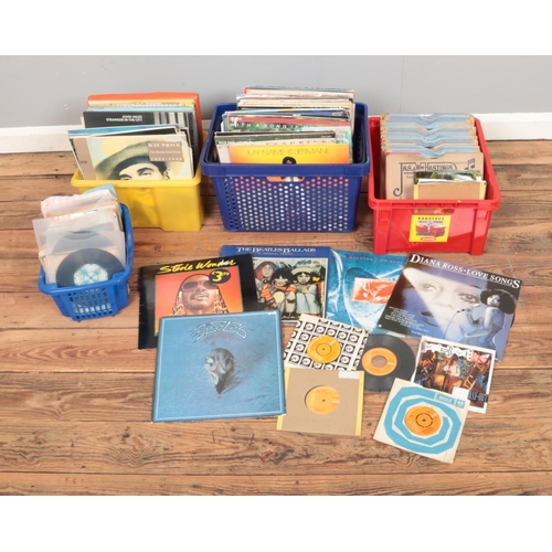 167 - Three boxes of assorted records and one box of singles to include David Bowie, Belinda Carlisle, Mot... 