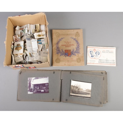 176 - A box containing a vintage photograph/postcard album and assorted cigarette cards, loose and in albu... 