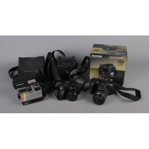 52 - Three cameras including Fujifilm Finepix HS10, Finepix S2950 and Polariod Supercolour.