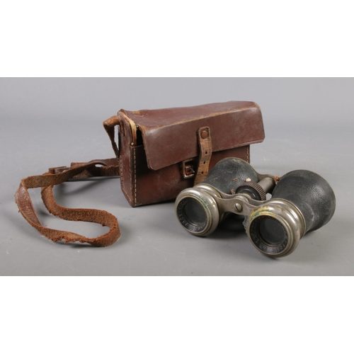 59 - A cased pair of Le Jockey Club binoculars.