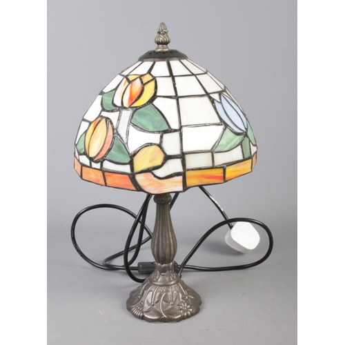 64 - A Tiffany style desk lamp featuring floral tulip design.