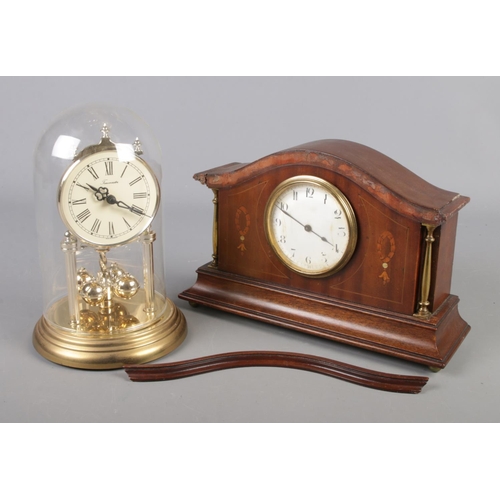 74 - An inlaid mahogany Buren mantel clock, along with a TimeMaster torsion clock with glass dome.