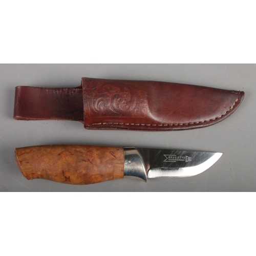 386 - A Norwegian Brusletto hunting/bush craft knife. With walnut grip, silver collar and leather sheath.