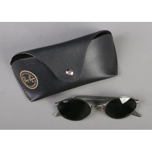 392 - A pair of cased Ray Ban sunglasses.