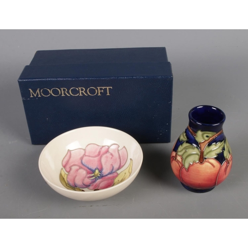 403 - Two pieces of Moorcroft pottery include Apples pedestal vase (boxed) and small magnolia white ground... 