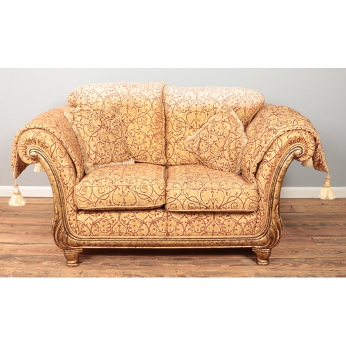 424 - A Barker & Stonehouse style two seater sofa with gilt and floral upholstery. Height 93cm, Width 180c... 