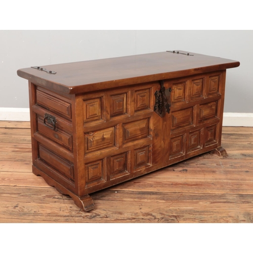 430 - A panelled hardwood blanket box with metal mounts.