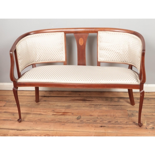 453 - A mahogany upholstered two seater salon sofa.